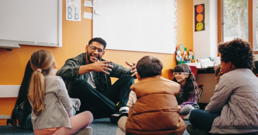 Stock image of teacher and kids sitting in circle